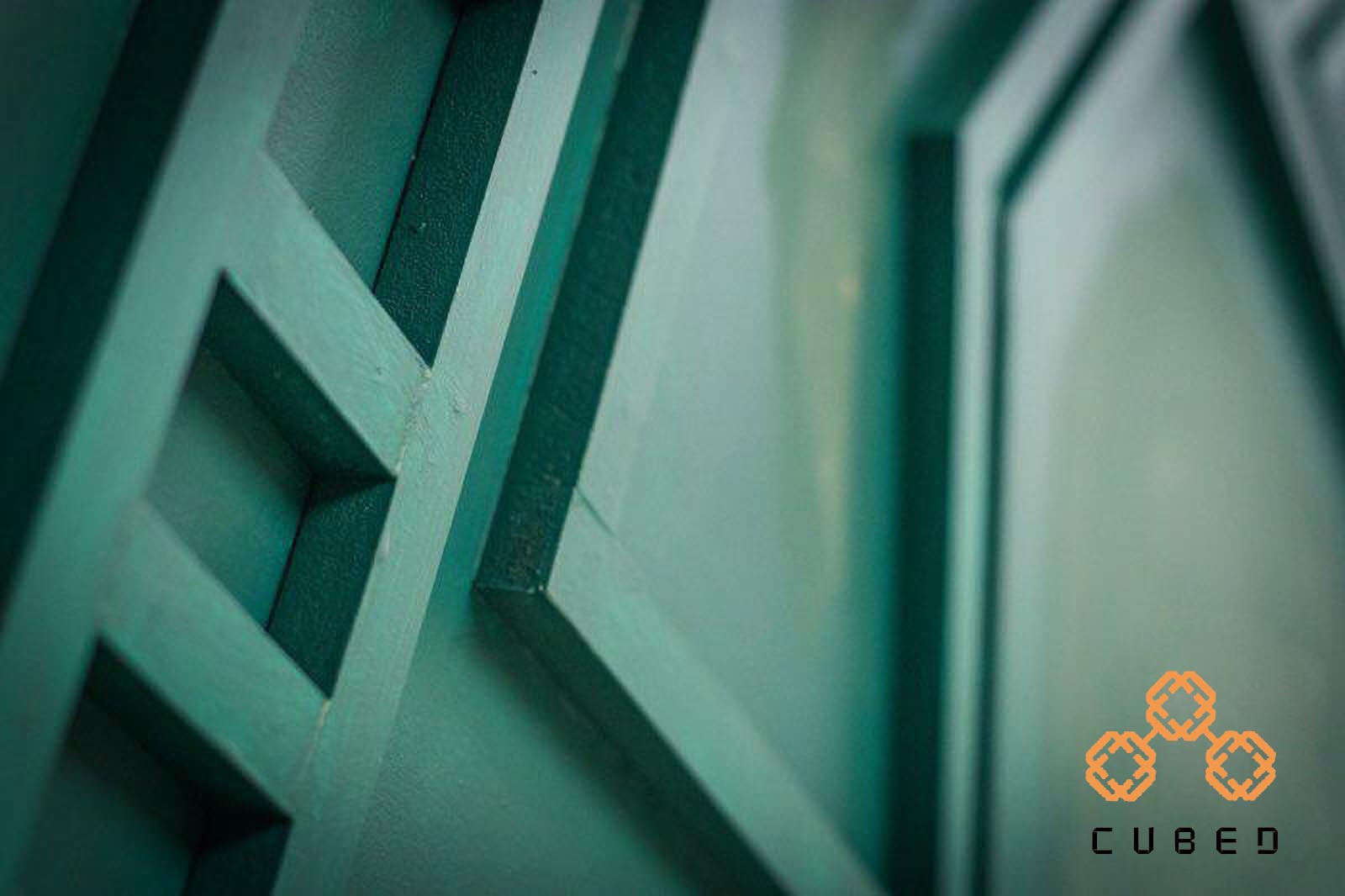A blurry shot of the green wall feature at cubed cuts and coffee.