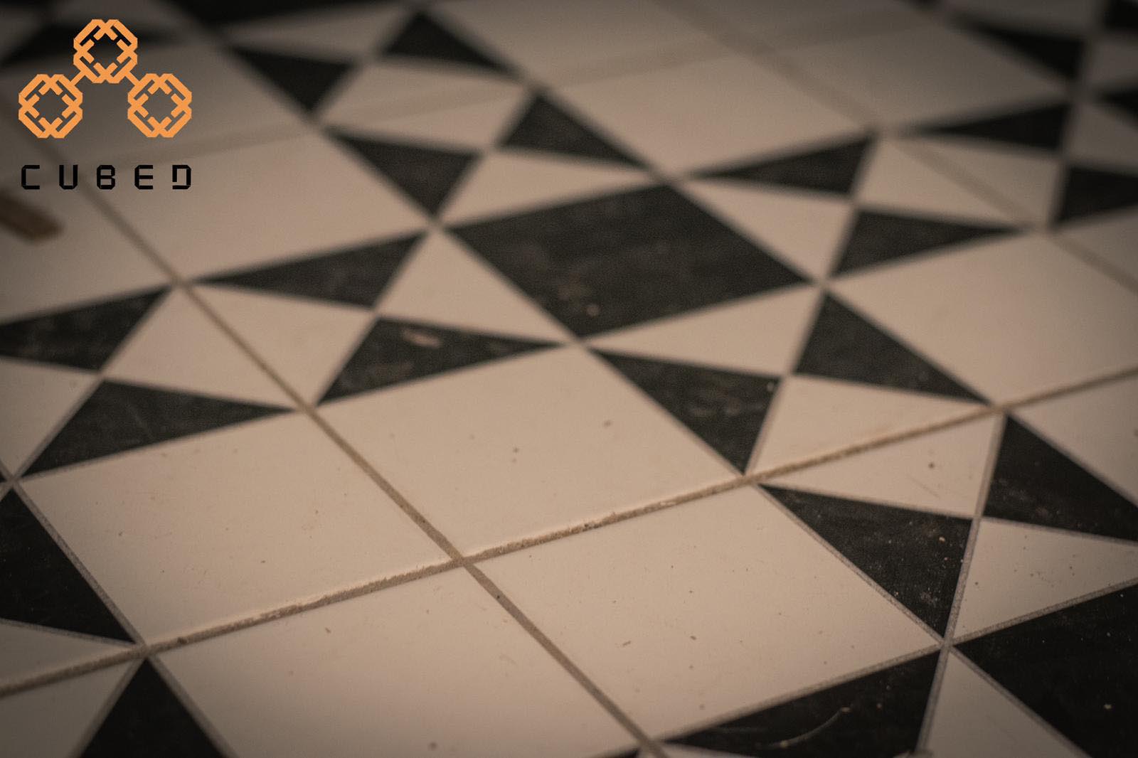 A blurry photograph of designer tiled flooring at cubed cuts and coffee for the Starting a business from scratch podcast