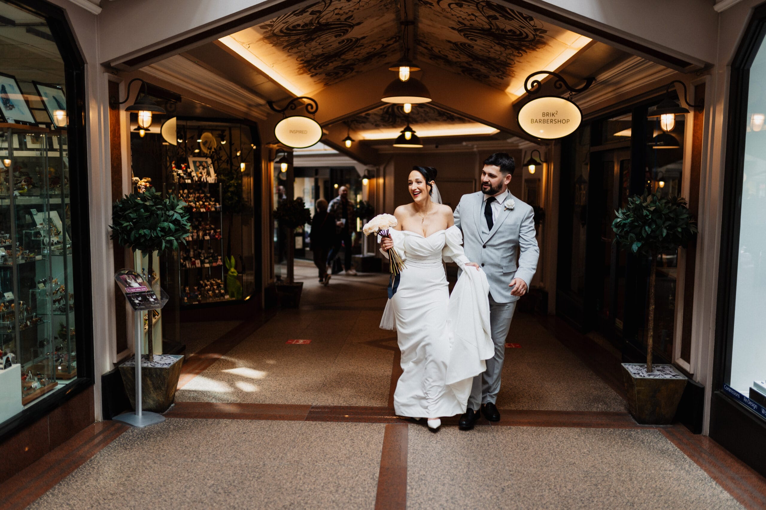 Couple smiling and walking through Flying Horse Walk in Nottingham