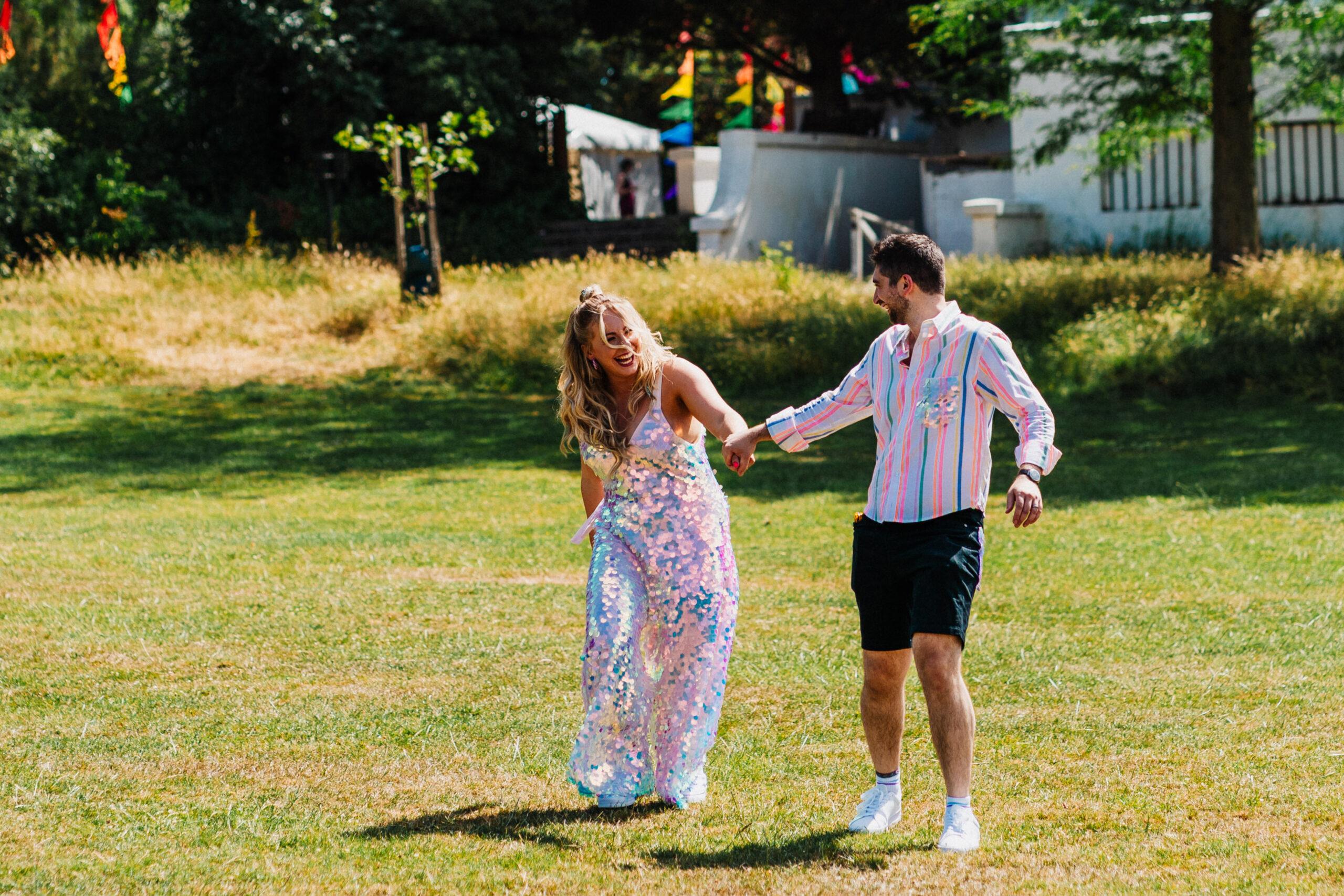 Couple share joyful moment dancing in garden, natural wedding photography at Bel Air House Dulwich